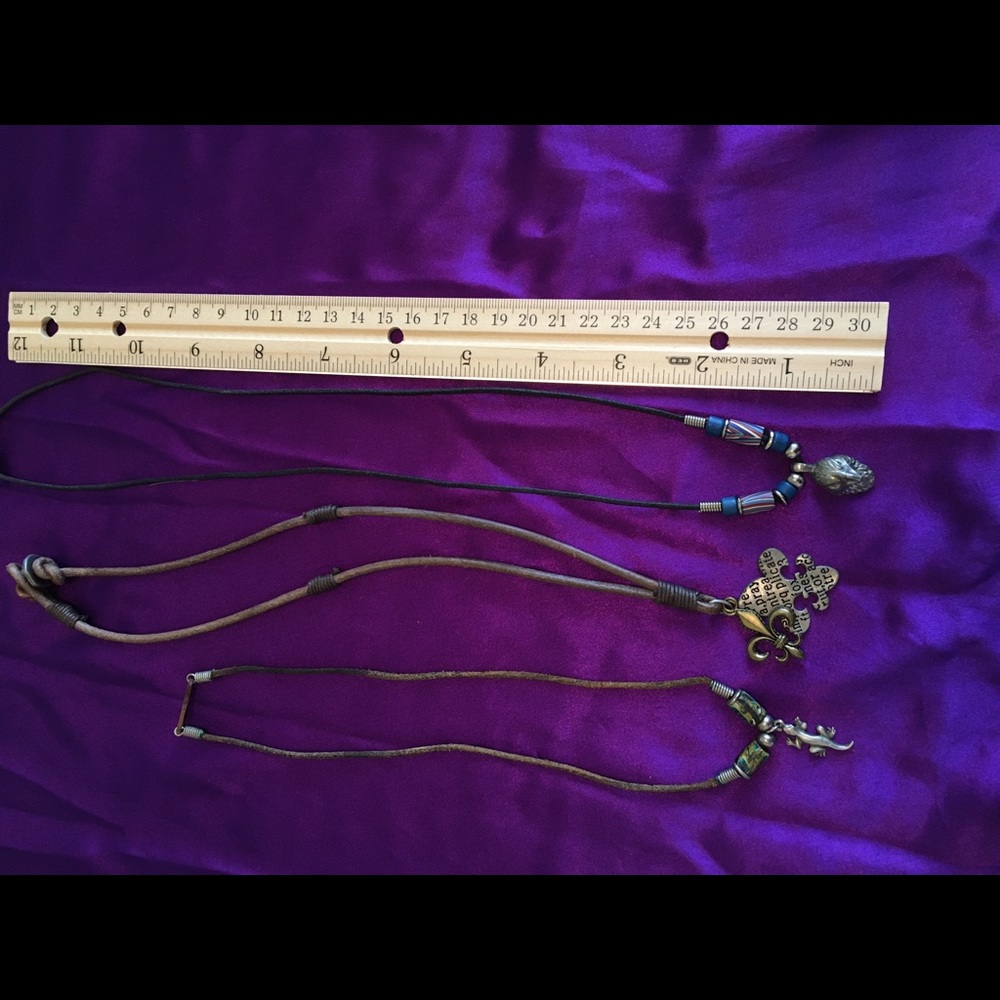 Three necklaces on leather cords.